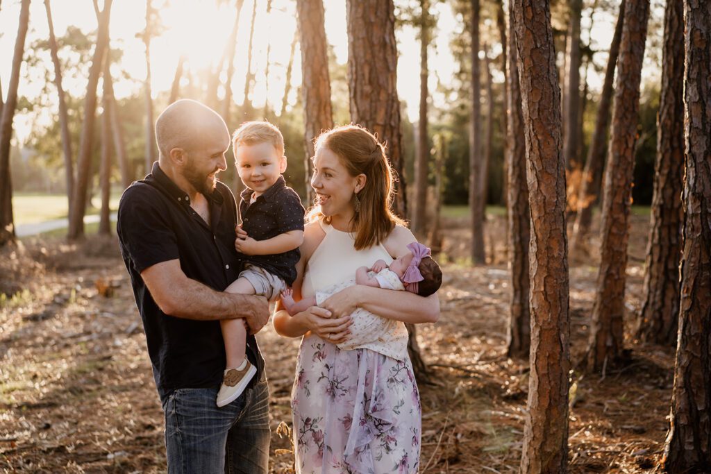 Dad, toddler, mum, and baby during a family photo session